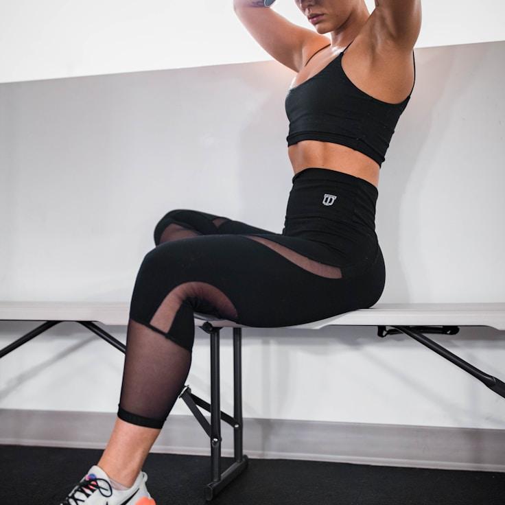 Women in a fitness class doing stretching and mobility exercises